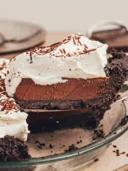 A whole no bake chocolate espresso pie with a slice of it being removed.