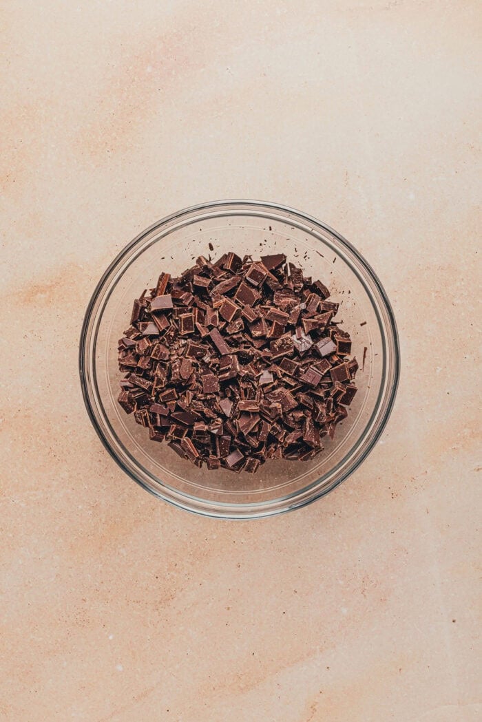 A glass bowl with chopped chocolate.