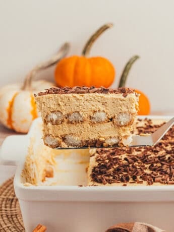 Slice of pumpkin spice tiramisu with layers of chai-soaked ladyfingers and pumpkin mascarpone cream