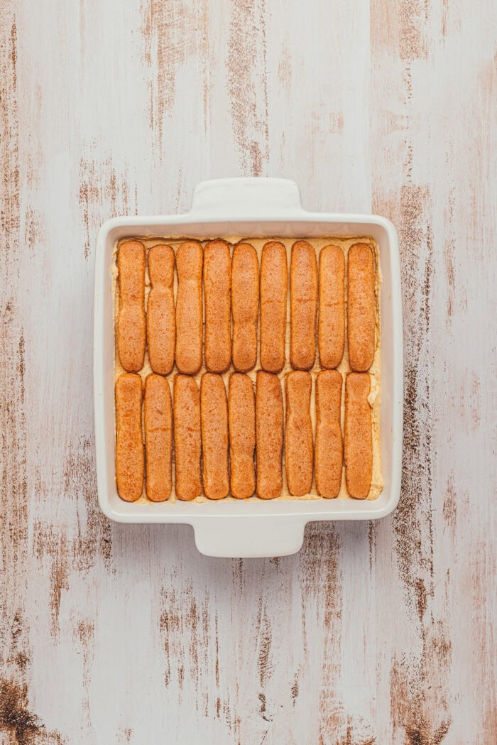 Chai-dipped ladyfingers topped with pumpkin cream in an 8-inch square dish