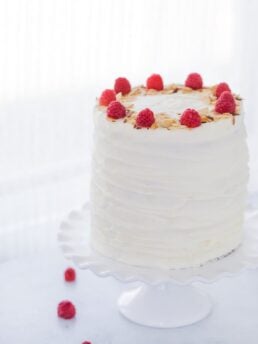 A luscious lemon raspberry cake recipe that is filled with a whipped honey mascarpone filling, raspberry compote and sweet cream cheese frosting.