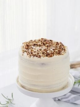 A classic hummingbird cake with a pineapple, banana and pecan spiced cake topped with cream cheese frosting. A moist spiced cake full of bold flavors.