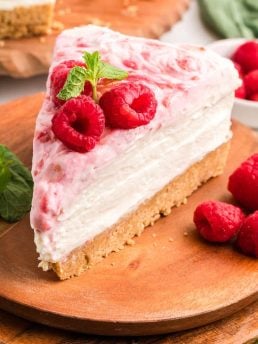 An up close image of a slice of no bake raspberry lemon cheesecake.