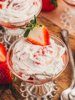 A glass parfait dish with homemade strawberry fool.