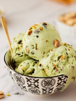 A bowl with many scoops of no churn Pistachio Ice cream.